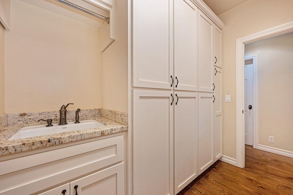 3557 Val Verde Road Loomis, CA 95650 - Photo 25 of 71 a bathroom with a granite countertop sink and white cabinets