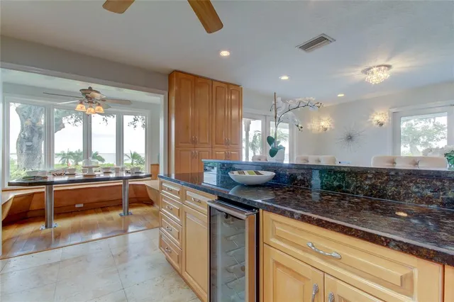 a kitchen with granite countertop white cabinets stainless steel appliances and sink