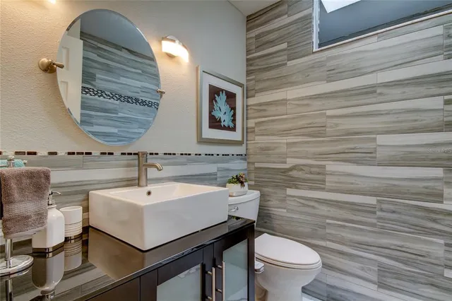 a view of a livingroom with furniture a bedroom wooden floor and windows