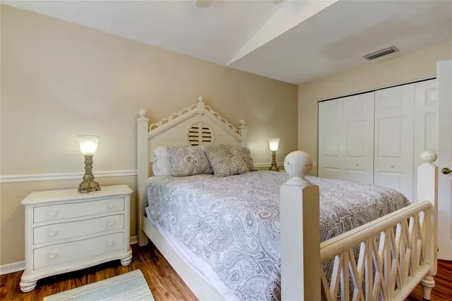 a bedroom with bed and wooden floor