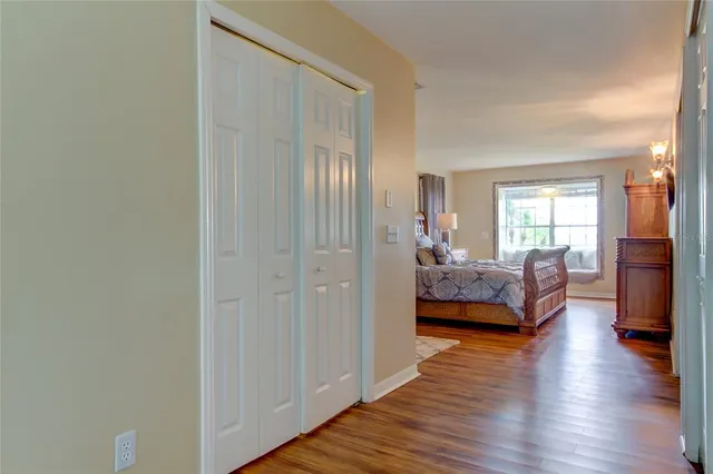 a view of a livingroom kitchen and hall with wooden floor