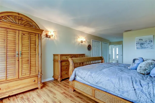 a dining room with wooden floor and large window