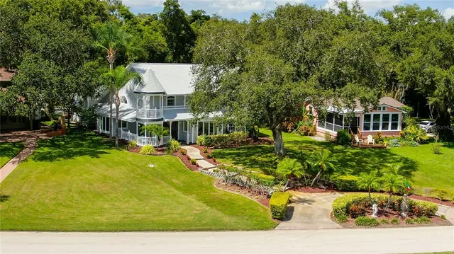 a view of a house with swimming pool and sitting area