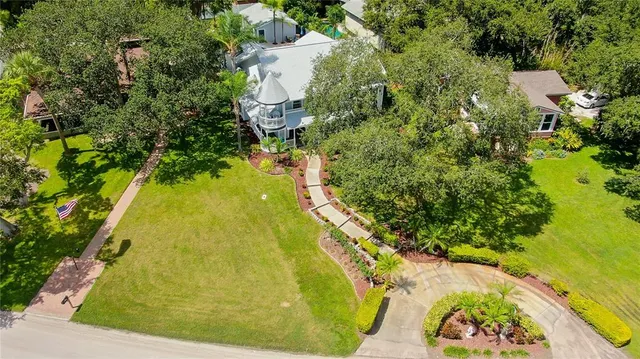 an aerial view of residential house with swimming pool and lawn chairs