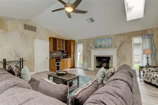a living room with furniture a fireplace and a flat screen tv