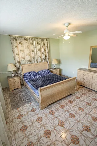 a bedroom with bed and wooden floor