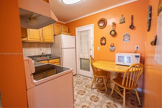 a view of a patio with a table chairs and a backyard