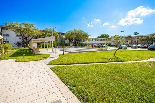 a view of a park with a big house