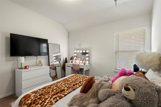 a bedroom with a bed and flat screen tv