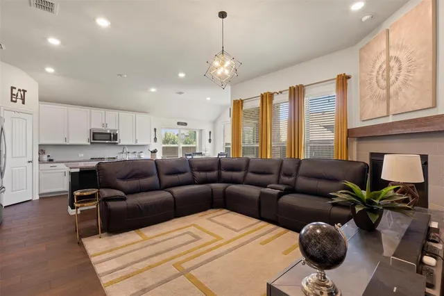 a living room with furniture and a chandelier