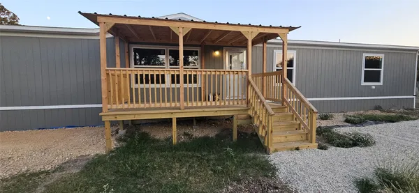 a view of a house with wooden fence