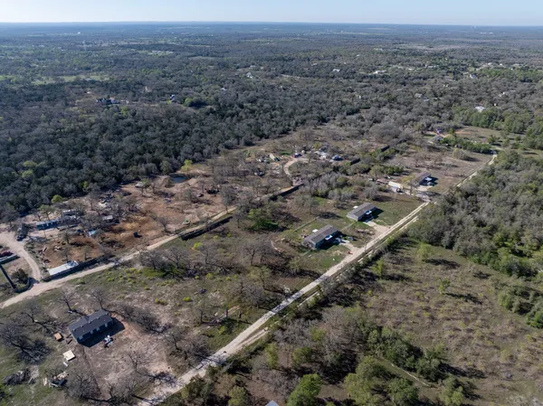 a view of a big yard with lots of trees