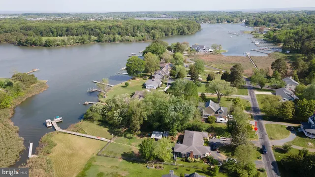 an aerial view of lake residential house with outdoor space and trees around