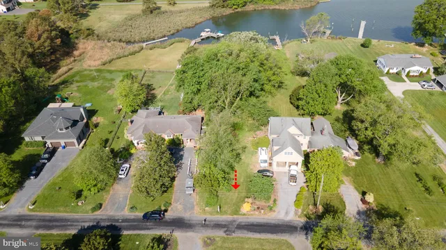 an aerial view of residential houses with outdoor space and swimming pool