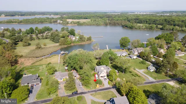 an aerial view of lake residential house with outdoor space and trees around