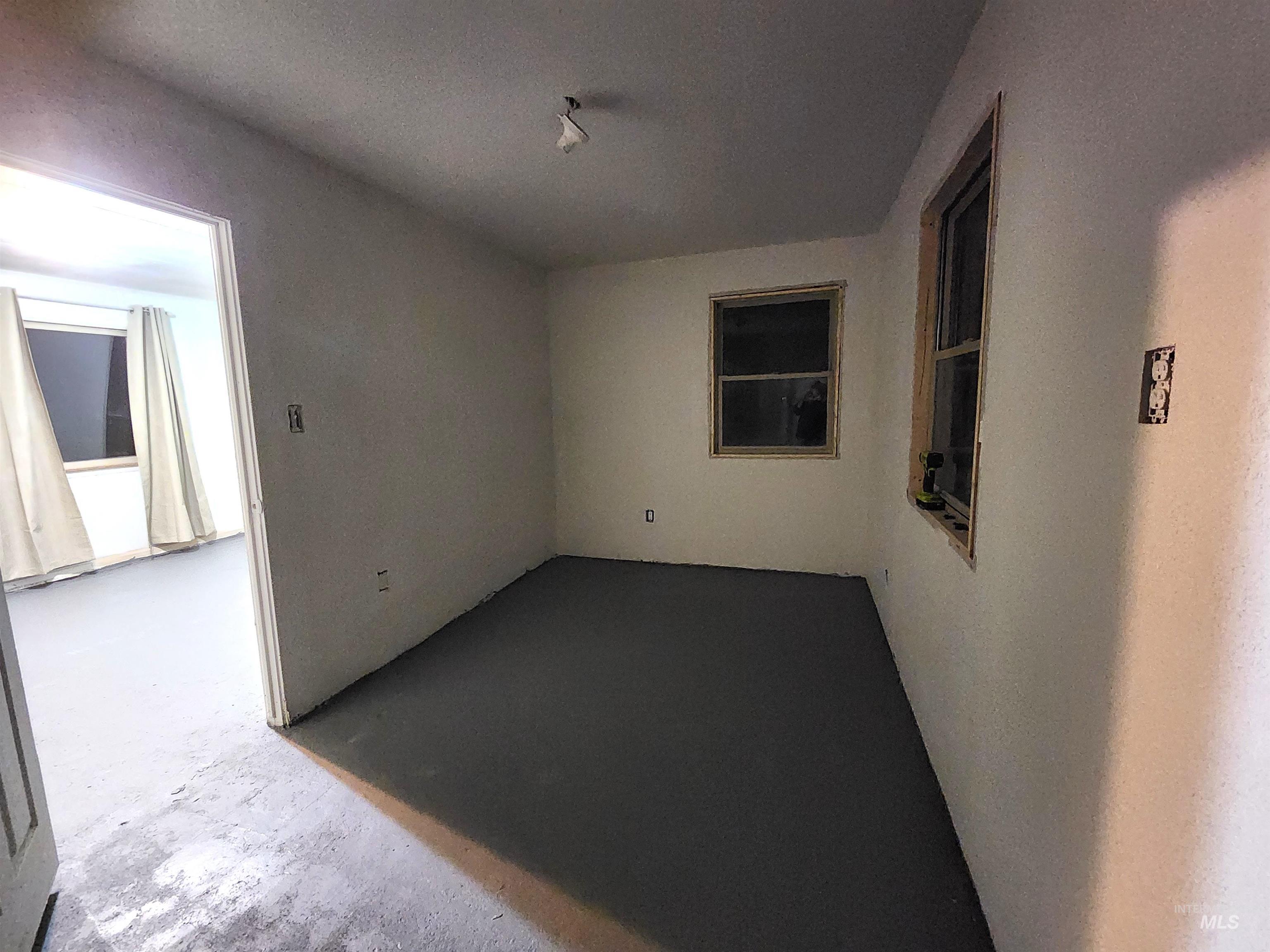 188 Morton Street West Vale, OR 97918 - Photo 3 of 9 Empty room with unfinished concrete floors