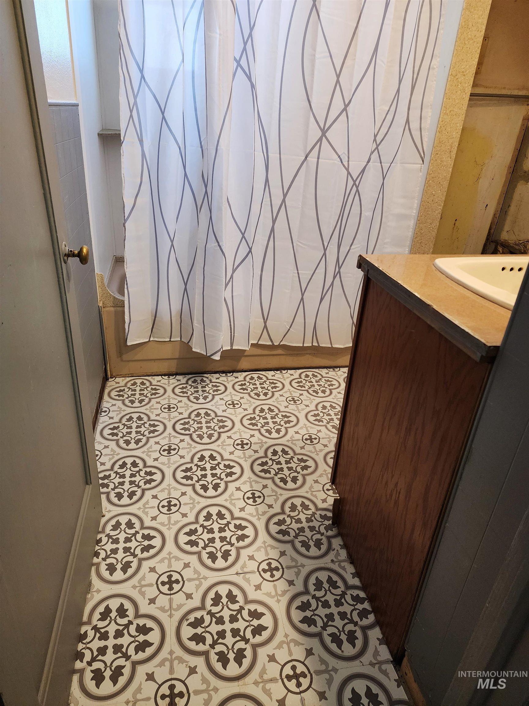 188 Morton Street West Vale, OR 97918 - Photo 6 of 9 Bathroom with vanity, light tile patterned floors, and a shower with curtain