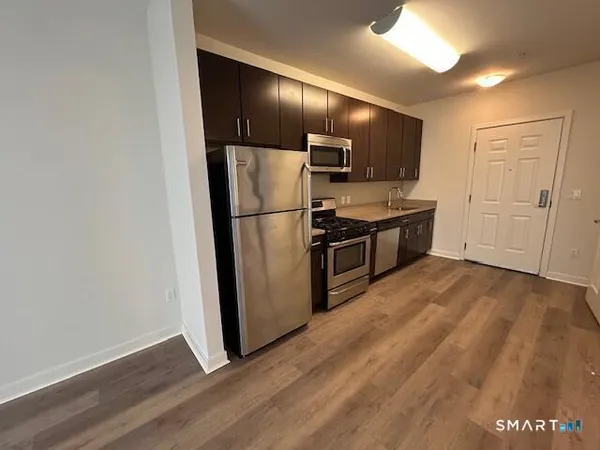 a kitchen with kitchen island white cabinets and stainless steel appliances