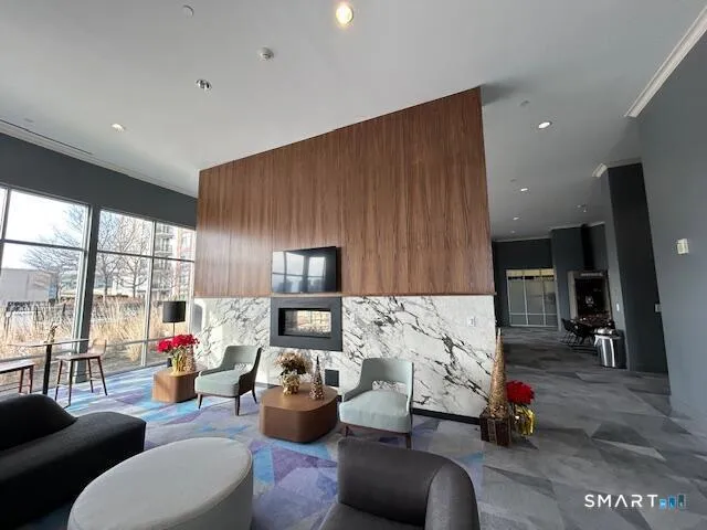 a living room with furniture gym equipment and a large window