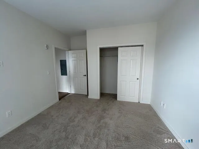 a view of an empty room and closet