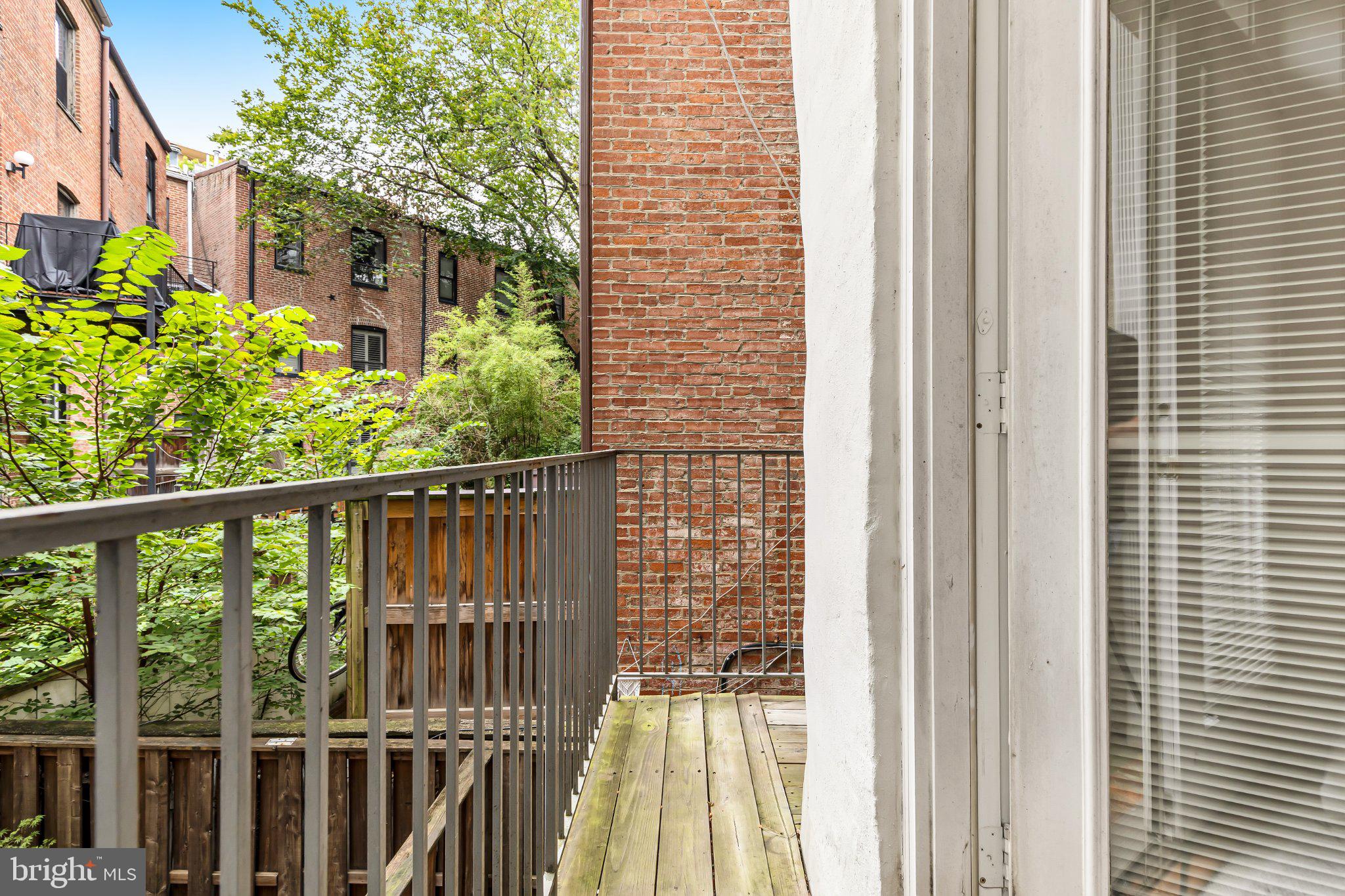 2201 K Street Northwest, Unit 4 Washington, DC 20037 - Photo 19 of 22 Charming balcony with lush greenery.