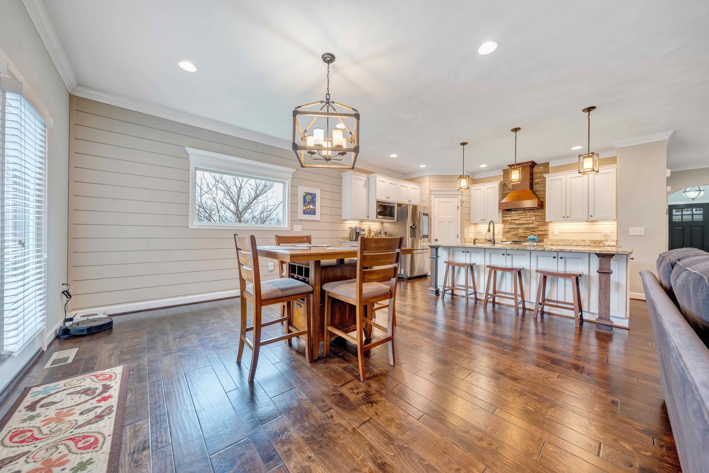 7041 Mountain Spring Trail Roanoke, VA 24018 - Photo 21 of 62 a view of a dining room with furniture wooden floor and chandelier