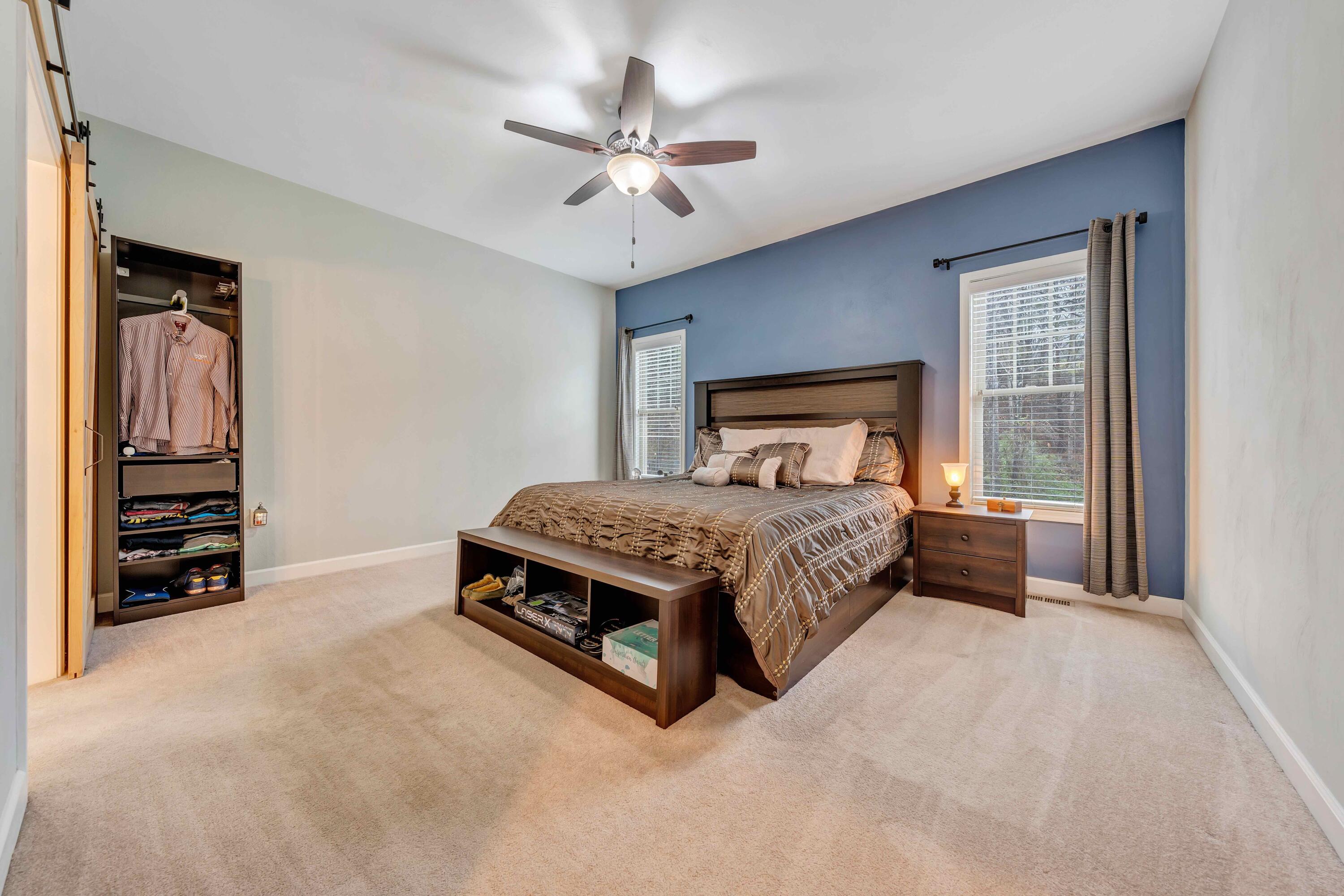 7041 Mountain Spring Trail Roanoke, VA 24018 - Photo 29 of 62 a bedroom with a large bed and a chandelier