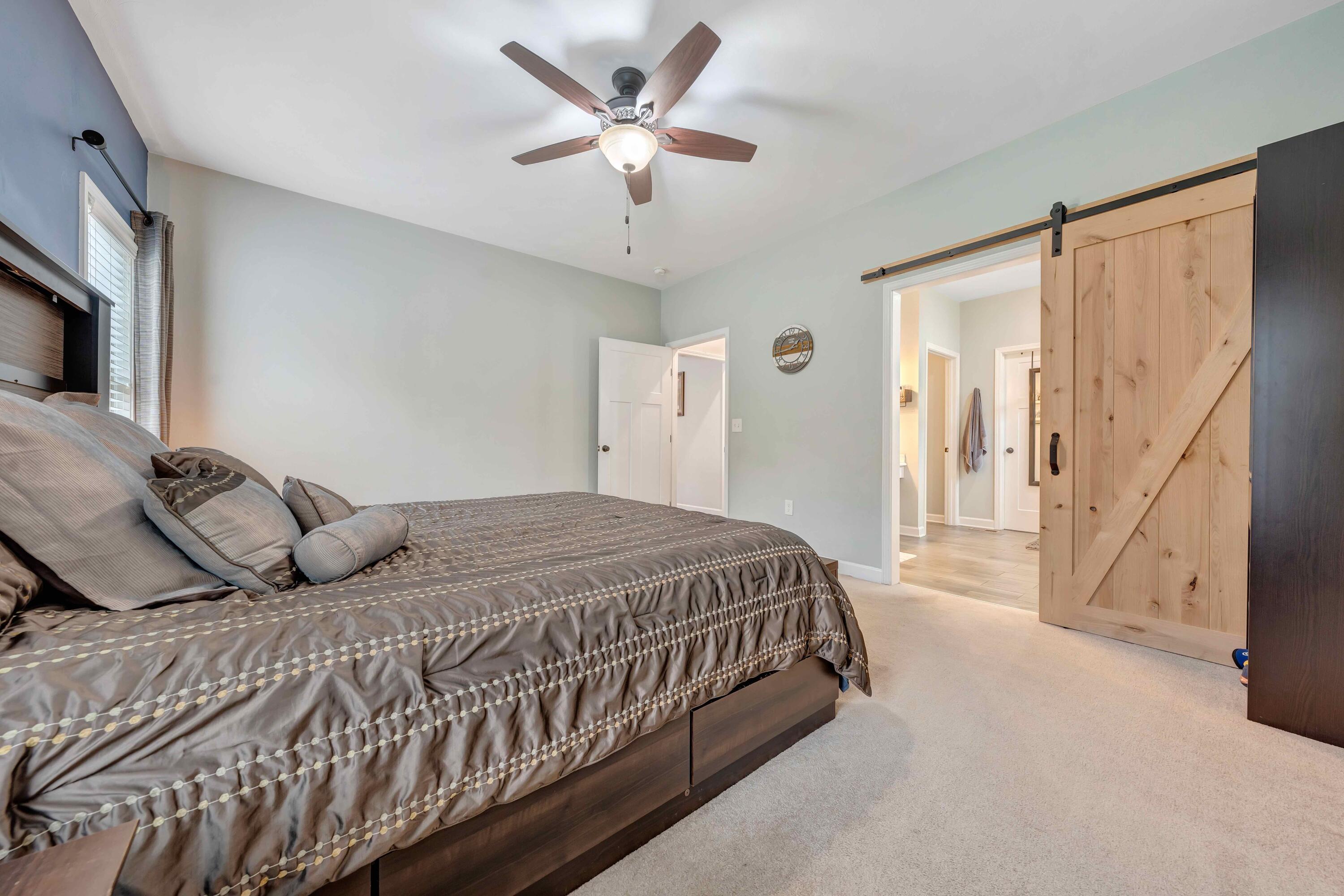 7041 Mountain Spring Trail Roanoke, VA 24018 - Photo 31 of 62 a bedroom with a large bed and a chandelier