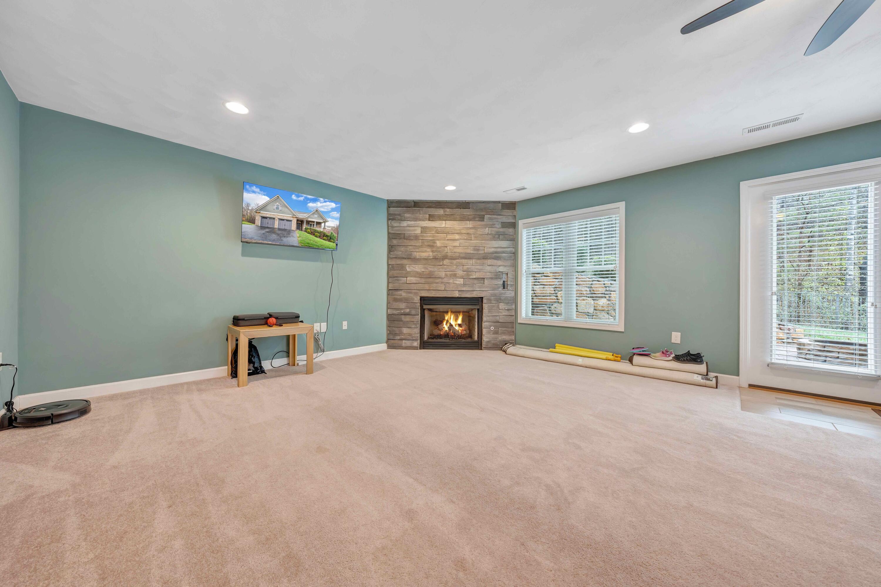 7041 Mountain Spring Trail Roanoke, VA 24018 - Photo 47 of 62 an empty room with furniture and a fireplace