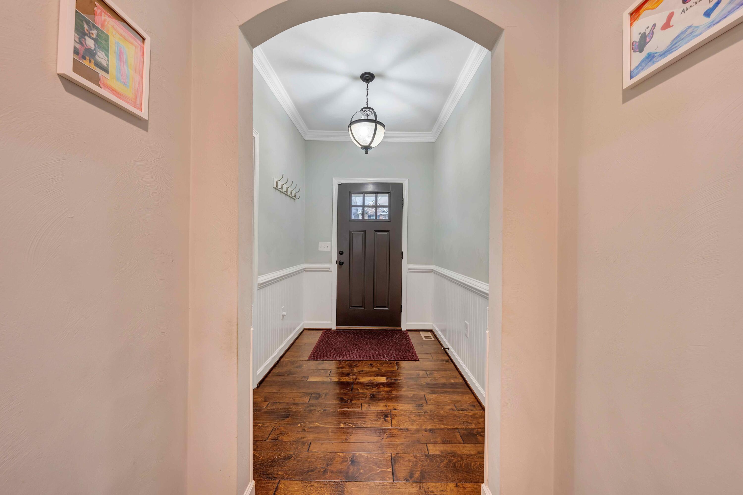 7041 Mountain Spring Trail Roanoke, VA 24018 - Photo 9 of 62 a view of a hallway with wooden floor and a dining room