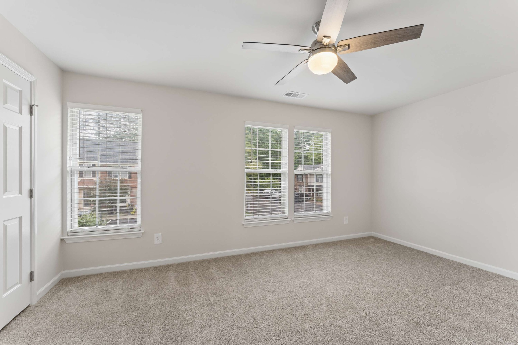 7100 Wheat Road Fairview, TN 37062 - Photo 20 of 25 an empty room with windows and ceiling fan