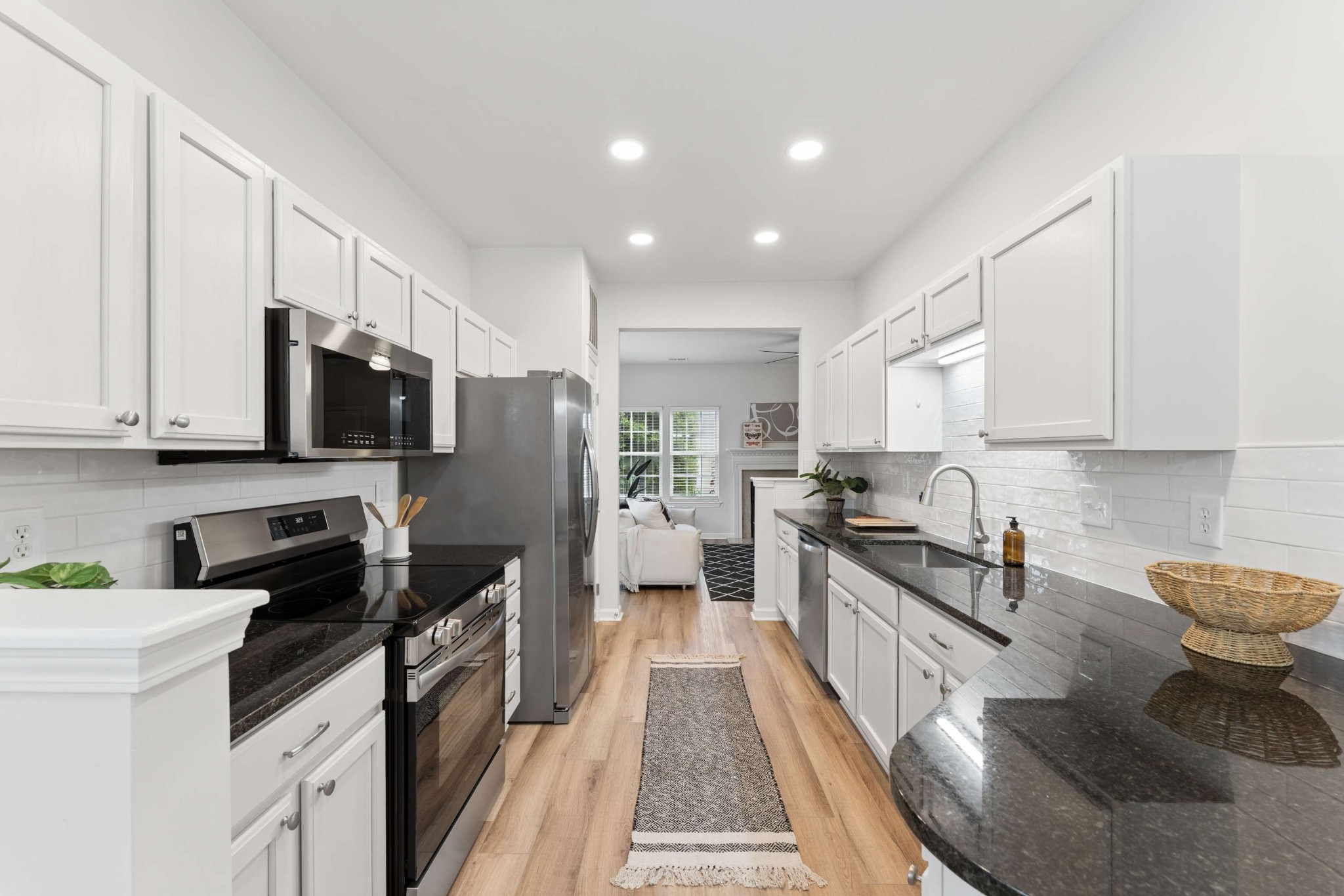 7100 Wheat Road Fairview, TN 37062 - Photo 5 of 25 a kitchen with granite countertop a sink a counter top space stainless steel appliances and cabinets