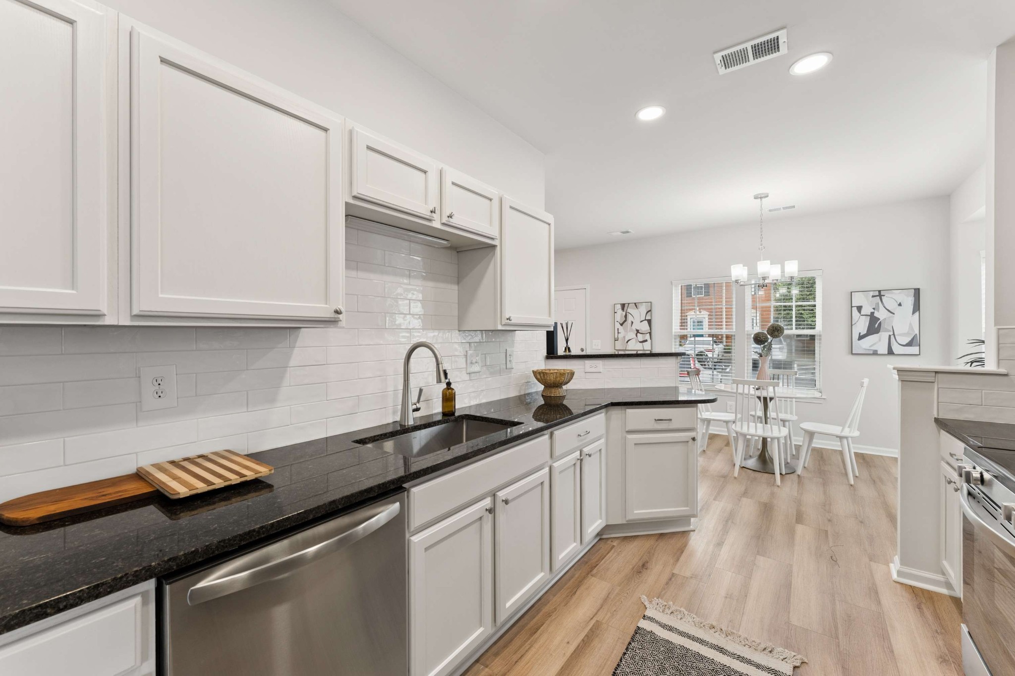 7100 Wheat Road Fairview, TN 37062 - Photo 6 of 25 a kitchen with white cabinets appliances and wooden floor