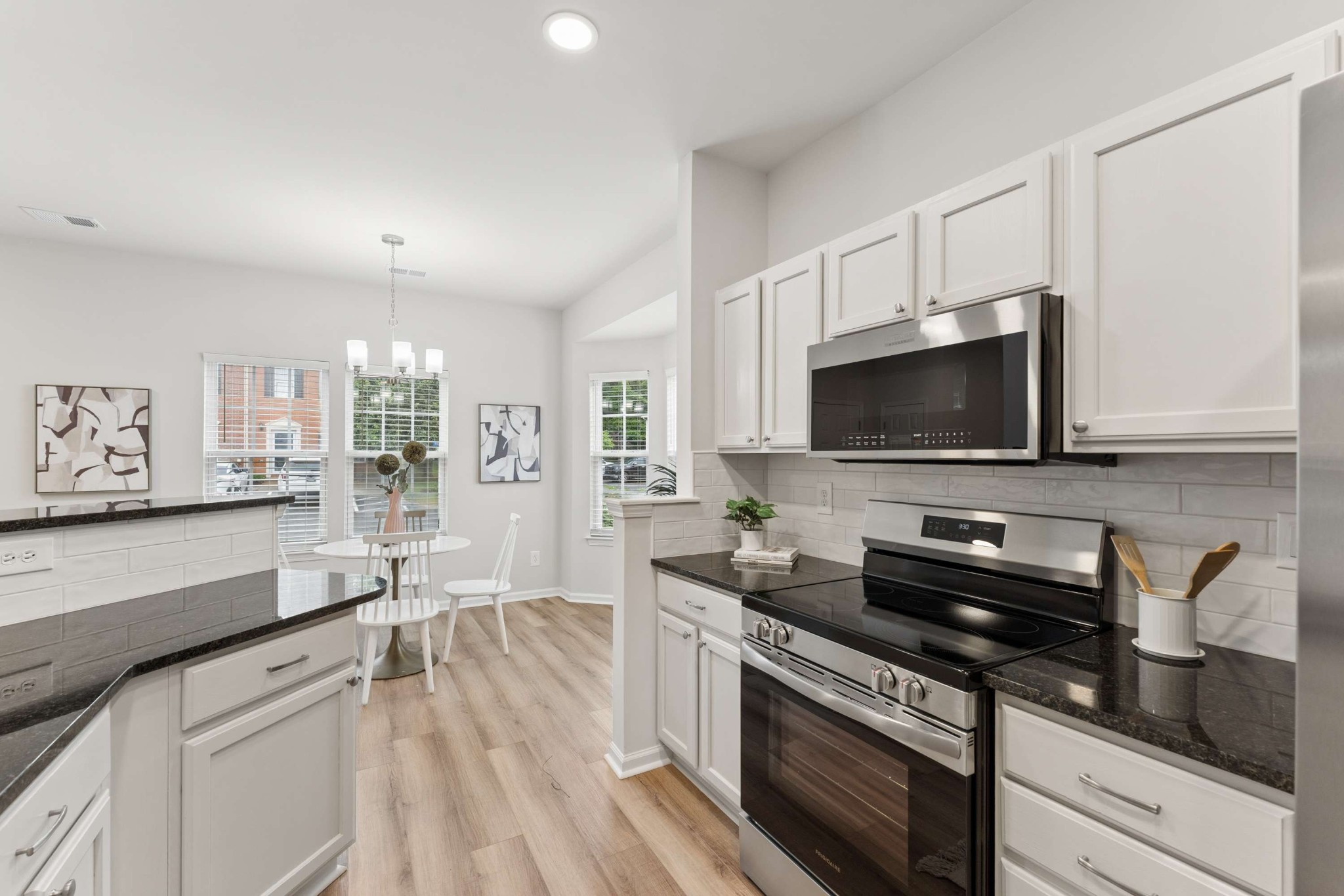 7100 Wheat Road Fairview, TN 37062 - Photo 7 of 25 a kitchen with stainless steel appliances a stove microwave and sink