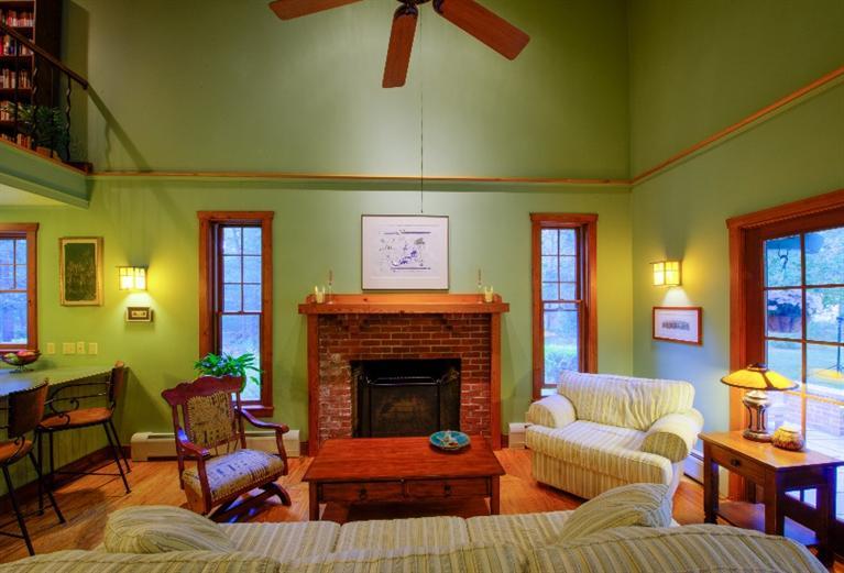 334 Old Oyster Road Cotuit, MA 02635 - Photo 3 of 17 a living room with furniture and a fireplace