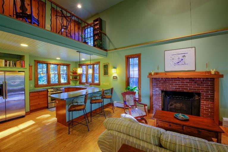 334 Old Oyster Road Cotuit, MA 02635 - Photo 4 of 17 a living room with furniture a flat screen tv and a fireplace