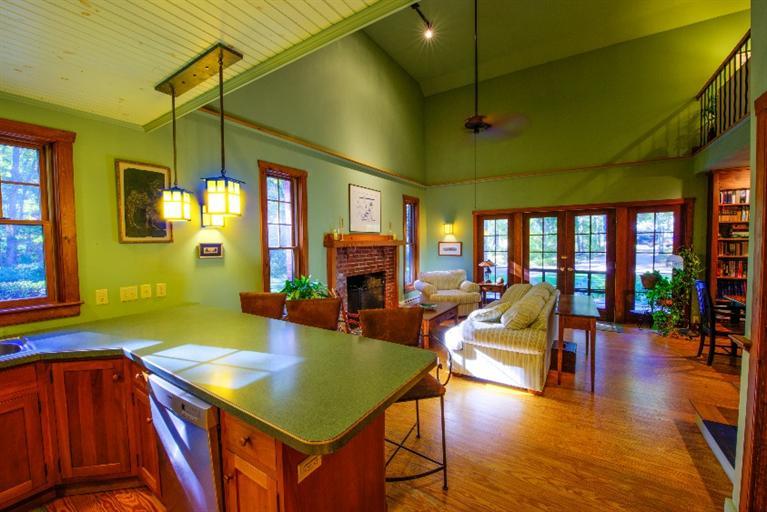 334 Old Oyster Road Cotuit, MA 02635 - Photo 5 of 17 a living room with furniture a dining table and paintings on the wall