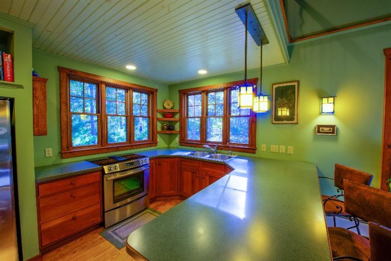 334 Old Oyster Road Cotuit, MA 02635 - Photo 6 of 17 a kitchen with stainless steel appliances granite countertop a barbecue grill and a dining table