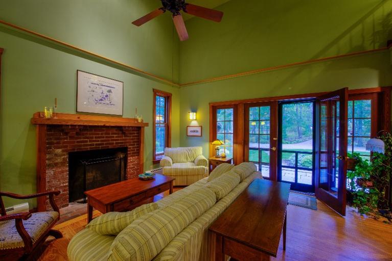 334 Old Oyster Road Cotuit, MA 02635 - Photo 8 of 17 a living room with furniture a fireplace and a potted plant