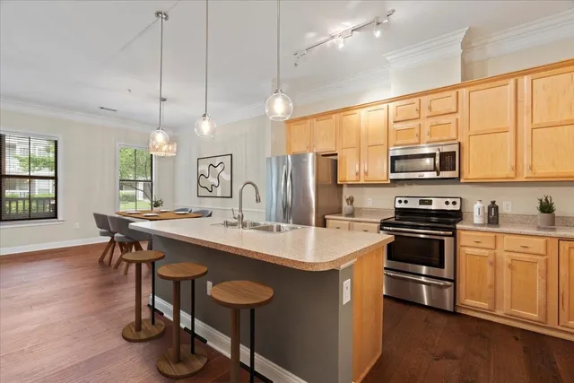 a kitchen with sink cabinets and wooden floor
