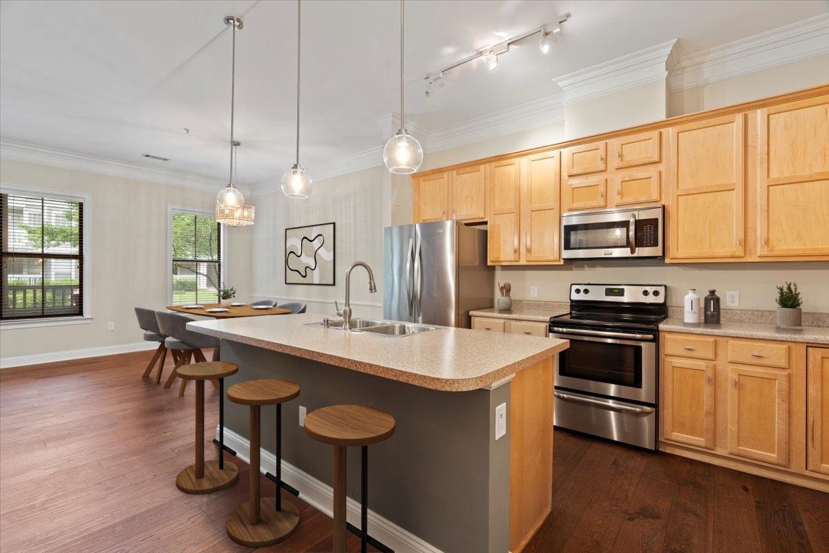 a kitchen with sink cabinets and wooden floor