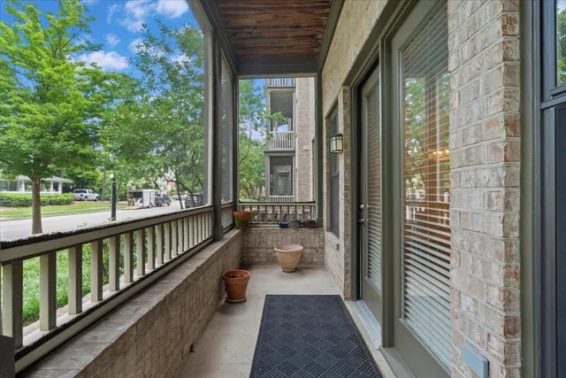 a view of a balcony with wooden floor