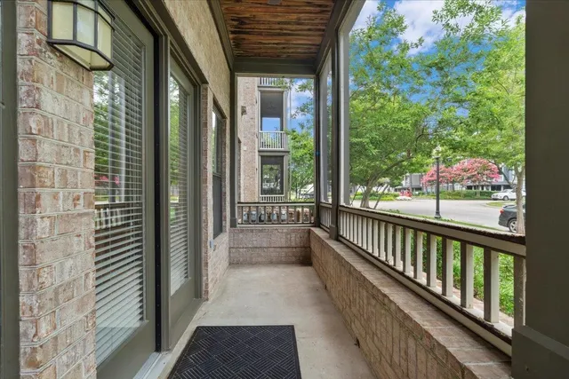 a view of a balcony with wooden floor