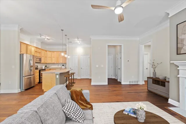 a living room with furniture and kitchen view