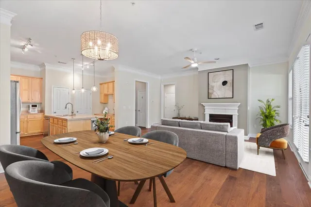 a view of a dining room with furniture a chandelier and wooden floor