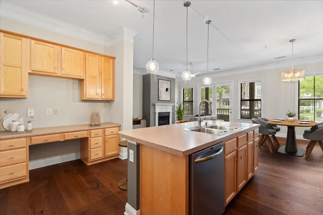 a large kitchen with kitchen island a sink a stove a dining table and chairs