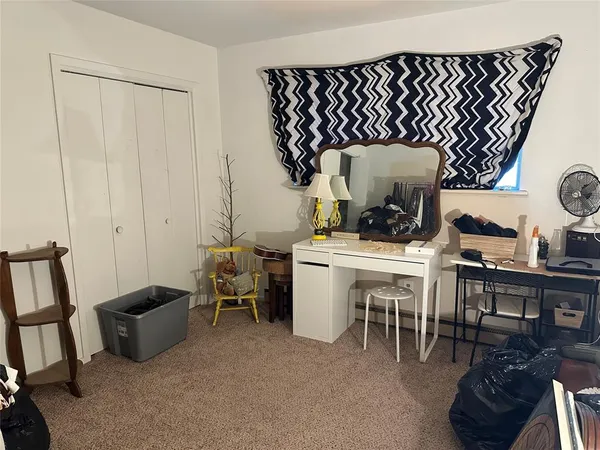 a living room with furniture a table and chair