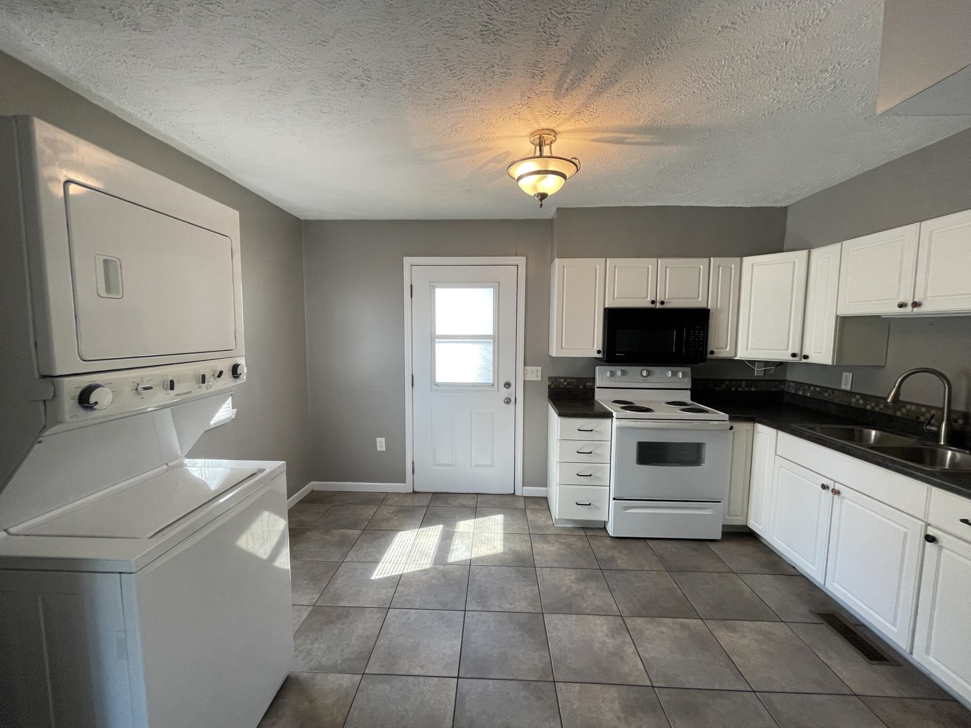 7412 Randy Road Machesney Park, IL 61115 - Photo 8 of 31 a kitchen with a stove a sink and a microwave