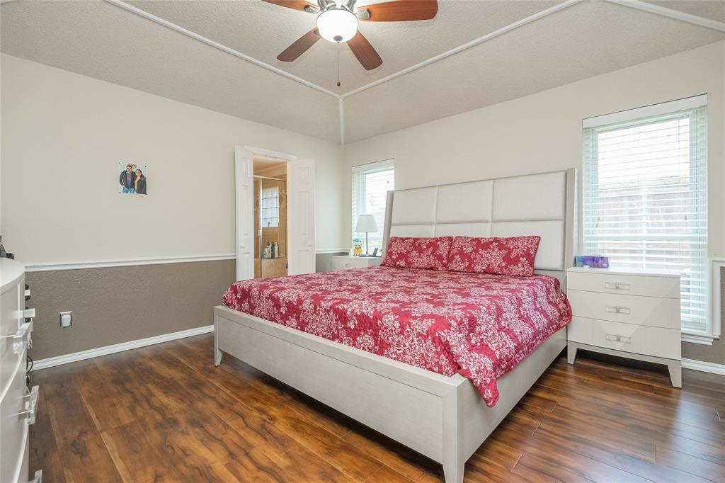 116 Meadowglen Circle Coppell, TX 75019 - Photo 19 of 32 a bedroom with a bed and a ceiling fan