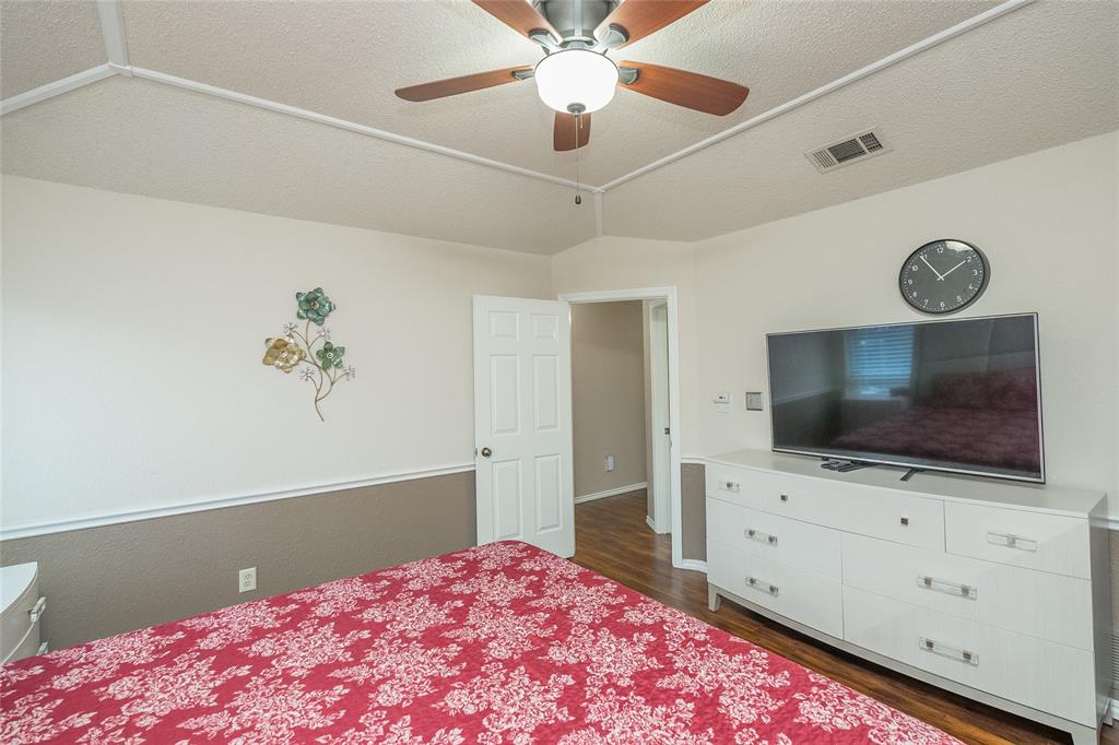 116 Meadowglen Circle Coppell, TX 75019 - Photo 21 of 32 a living room with a flat screen tv and a bookshelf